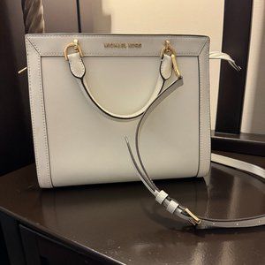 Michael Kors leather handbag with two top handles and single should strap.